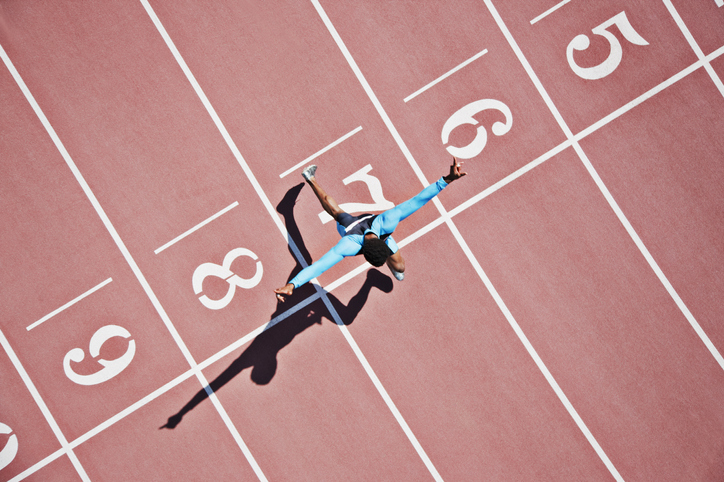 Runner crossing finishing line on track