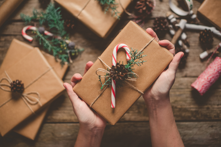 wrapped present with a candy cane and holly