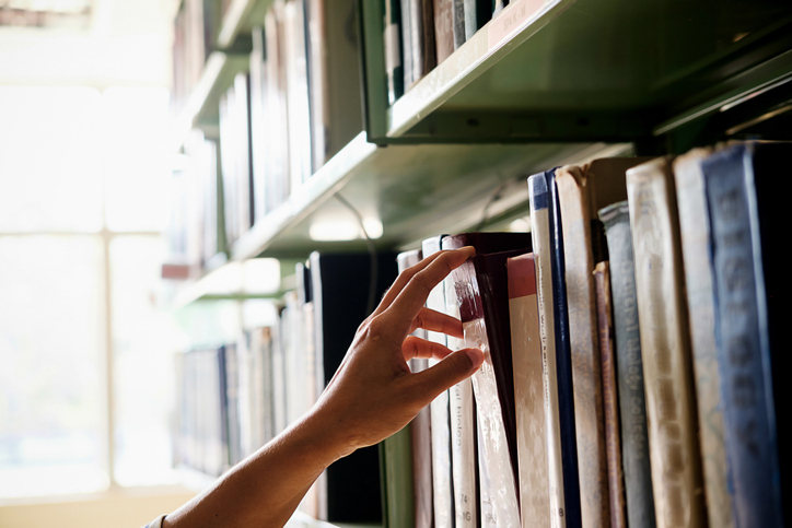 hand reaching for books