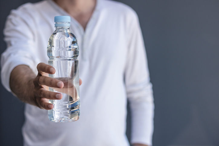 Advocacy strategies, man holding out water bottle