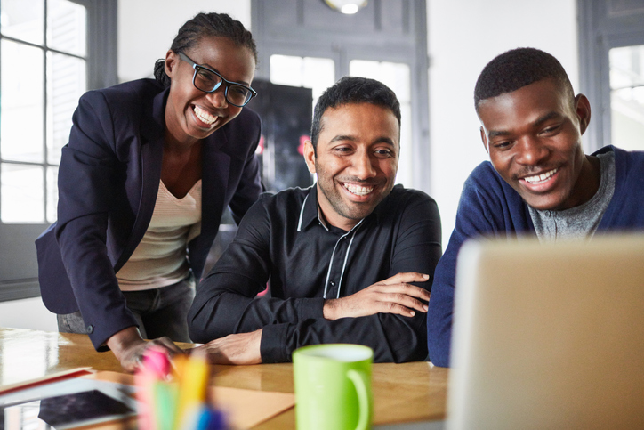 Three young people working at a paid internship