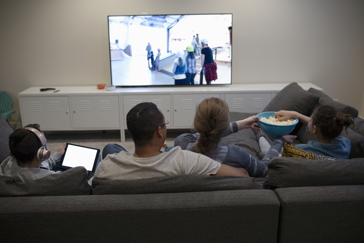 holiday-season people watching tv with popcorn