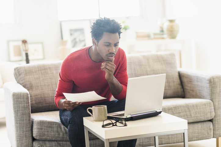 Man looking at computer/documents Advocacy RFP