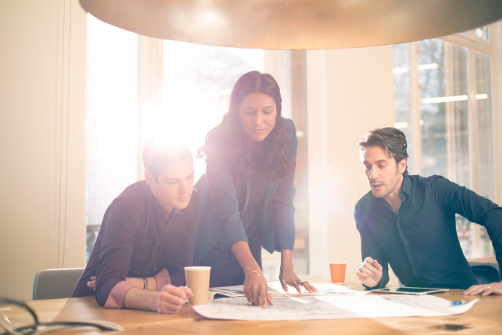 Advocacy RFP Woman pointing to document in front of two men