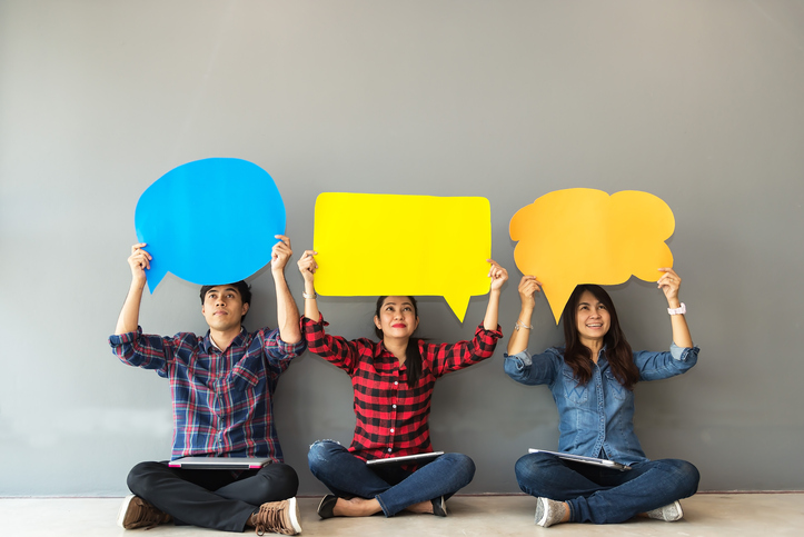 Membership surveys three people sitting holding paper thought bubbles above 