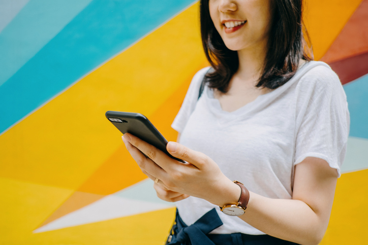 Woman smiling at phone - Political Campaign Ads