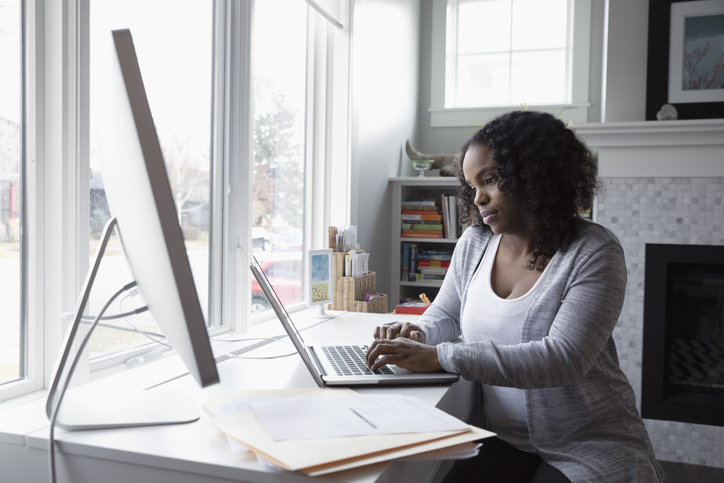 A woman looking at her political campaign website at her home. 