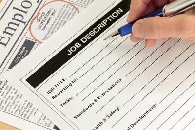 close up of someone writing out  a campaign job application