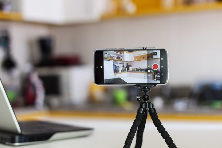 Set up for Facebook Live. An iPhone on a tripod on top of a desk. 