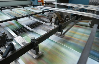 paper stock paper going fast on a big printer
