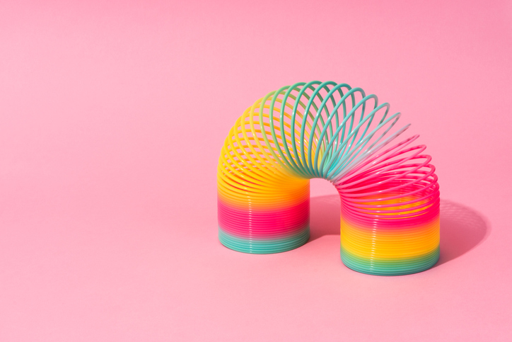 Rainbow slinky on a pink backdrop