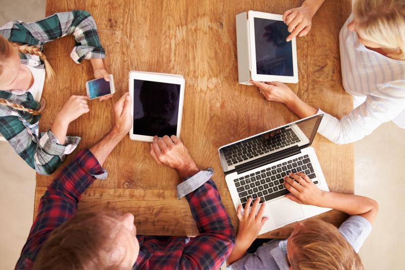 birds eye view of a table with people using their technology