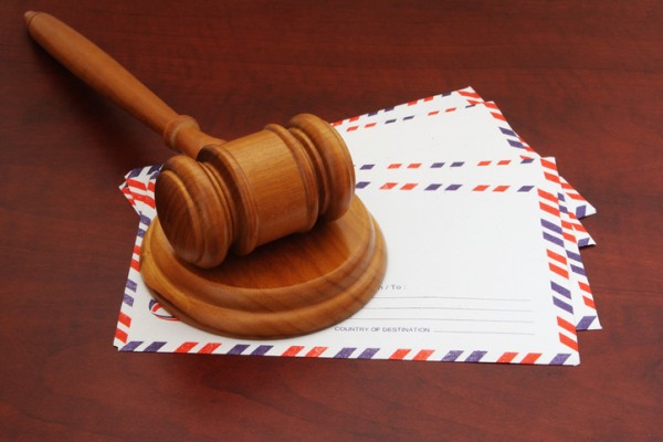 Judge's gavel on top of envelopes