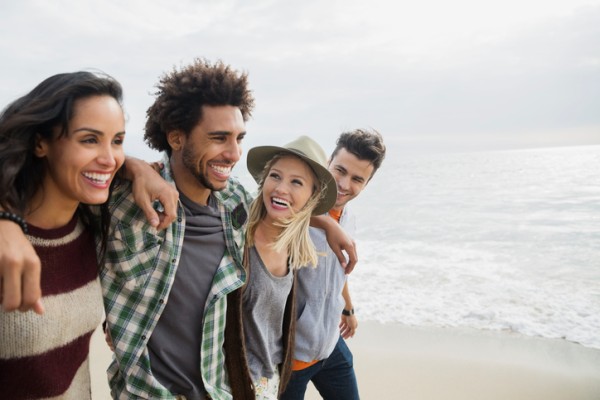 Social Pressure - Group of friends on the beach hanging out. 