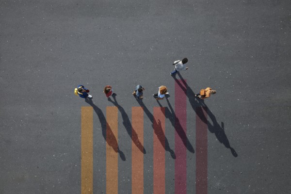 People walking in line on bar chart painted on asphalt -