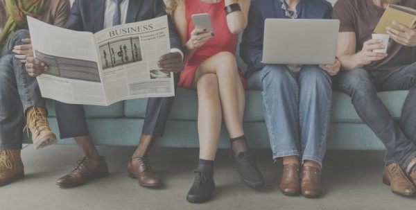 people sitting and reading newspapers