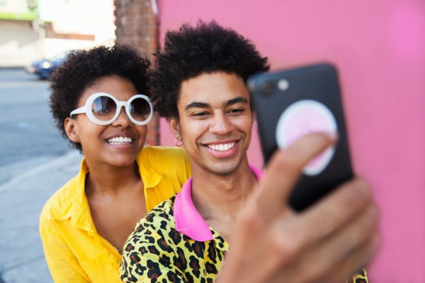 Young folks using social media on a cell phone