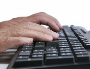 hands typing on a keyboard