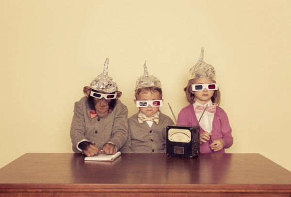 Monkey and kids wearing tin foil hats and 3D movie glasses with radio and notepad