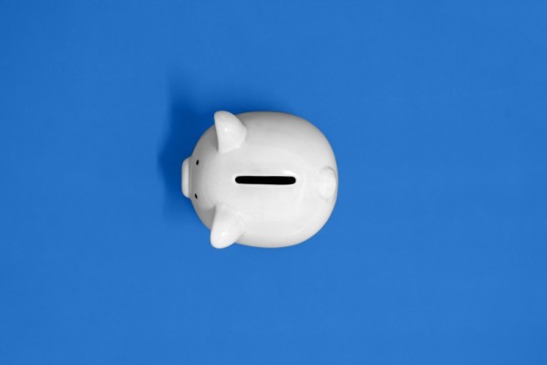 white piggy bank facing left with a blue background